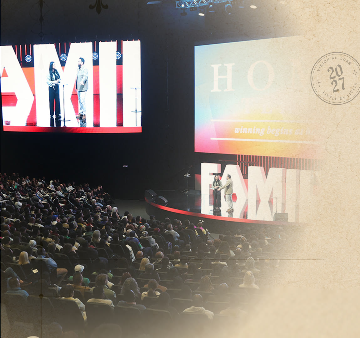 The Home Team on stage in a full auditorium