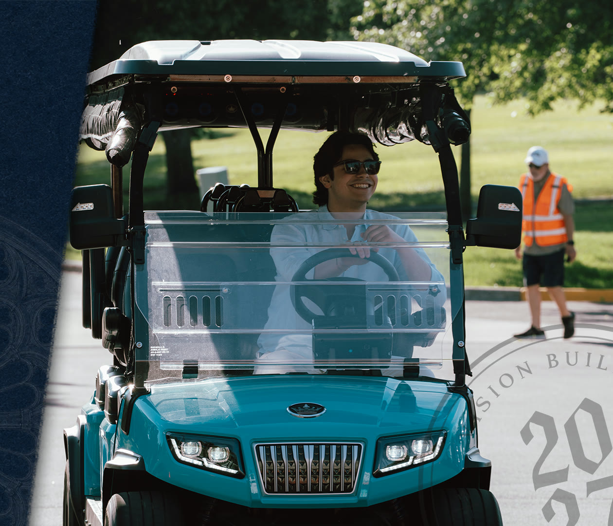 A shuttle cart driver on the church campus