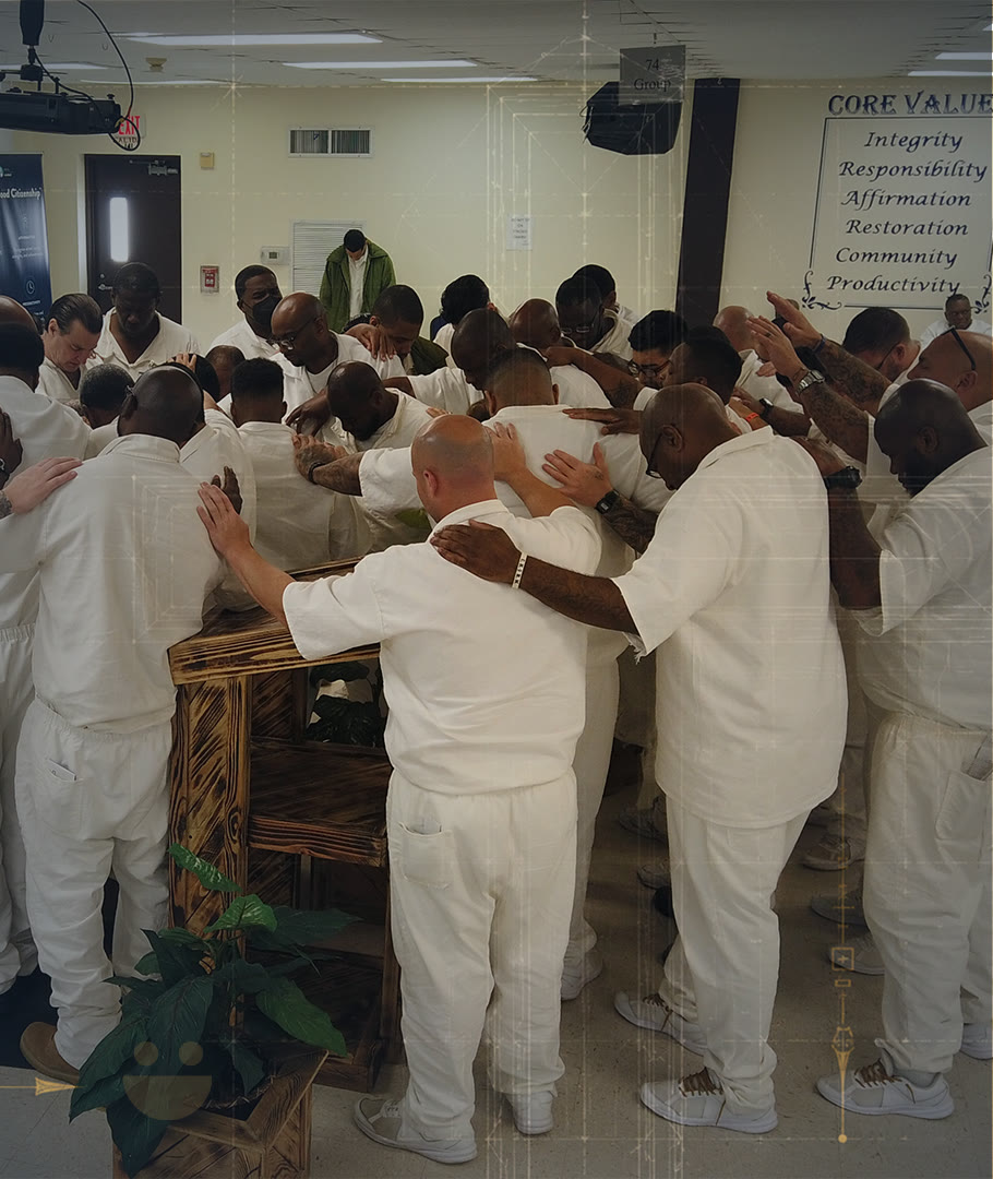 A prayer circle at a prison ministry gathering