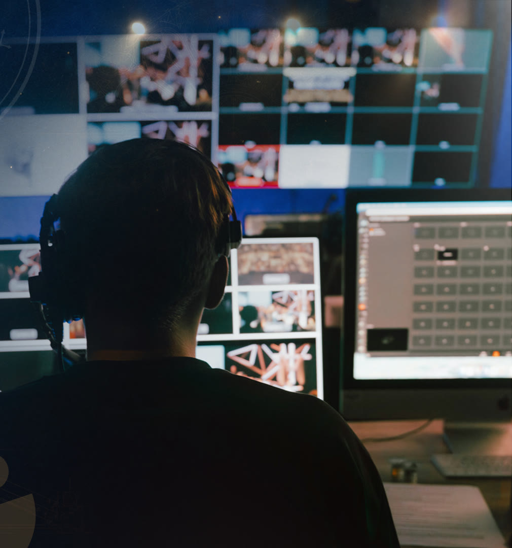 An engineer at a broadcast control desk